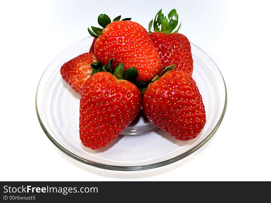 Strawberries on plate over white background