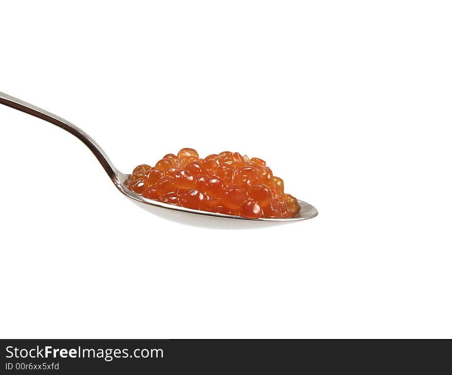 The spoon with red caviar isolated on a white background