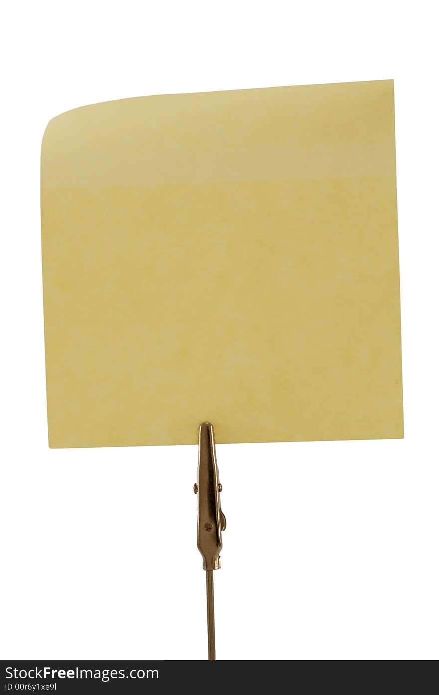 Clamp holding one yellow post-it, isolated on white. Clamp holding one yellow post-it, isolated on white.