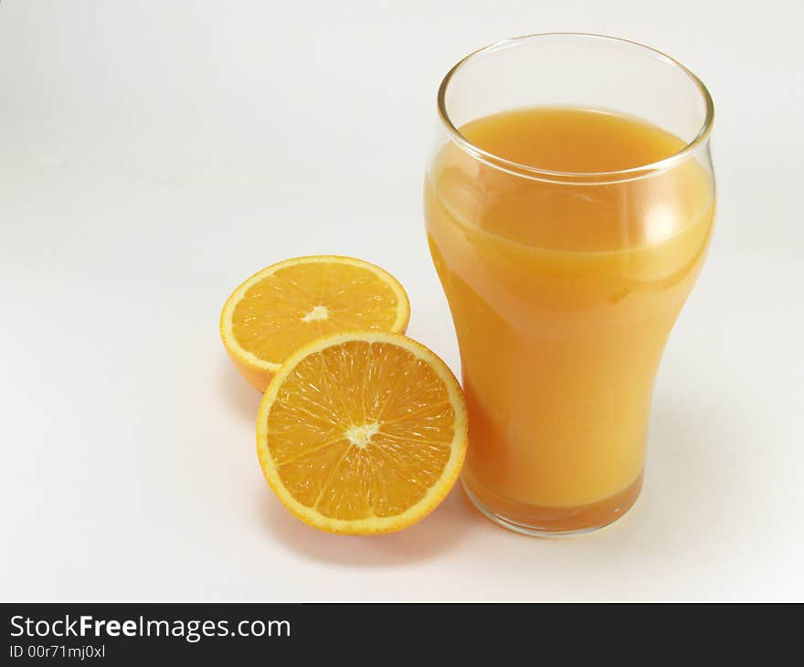 Oranges and glass of orange juice on a white background