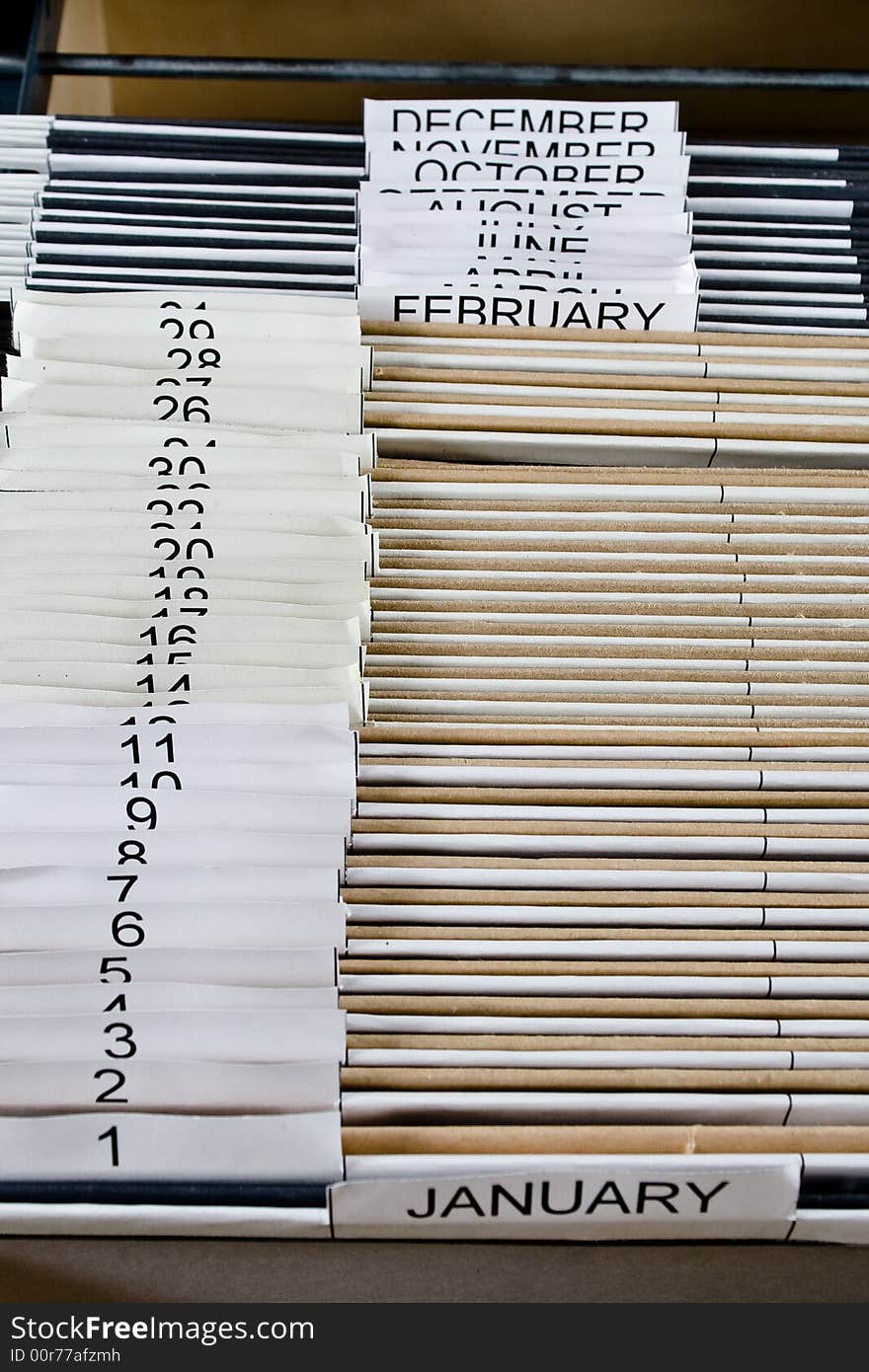 Wooden rolling file cabinet with a drawer opened, showing 43 hanging folders. Wooden rolling file cabinet with a drawer opened, showing 43 hanging folders.