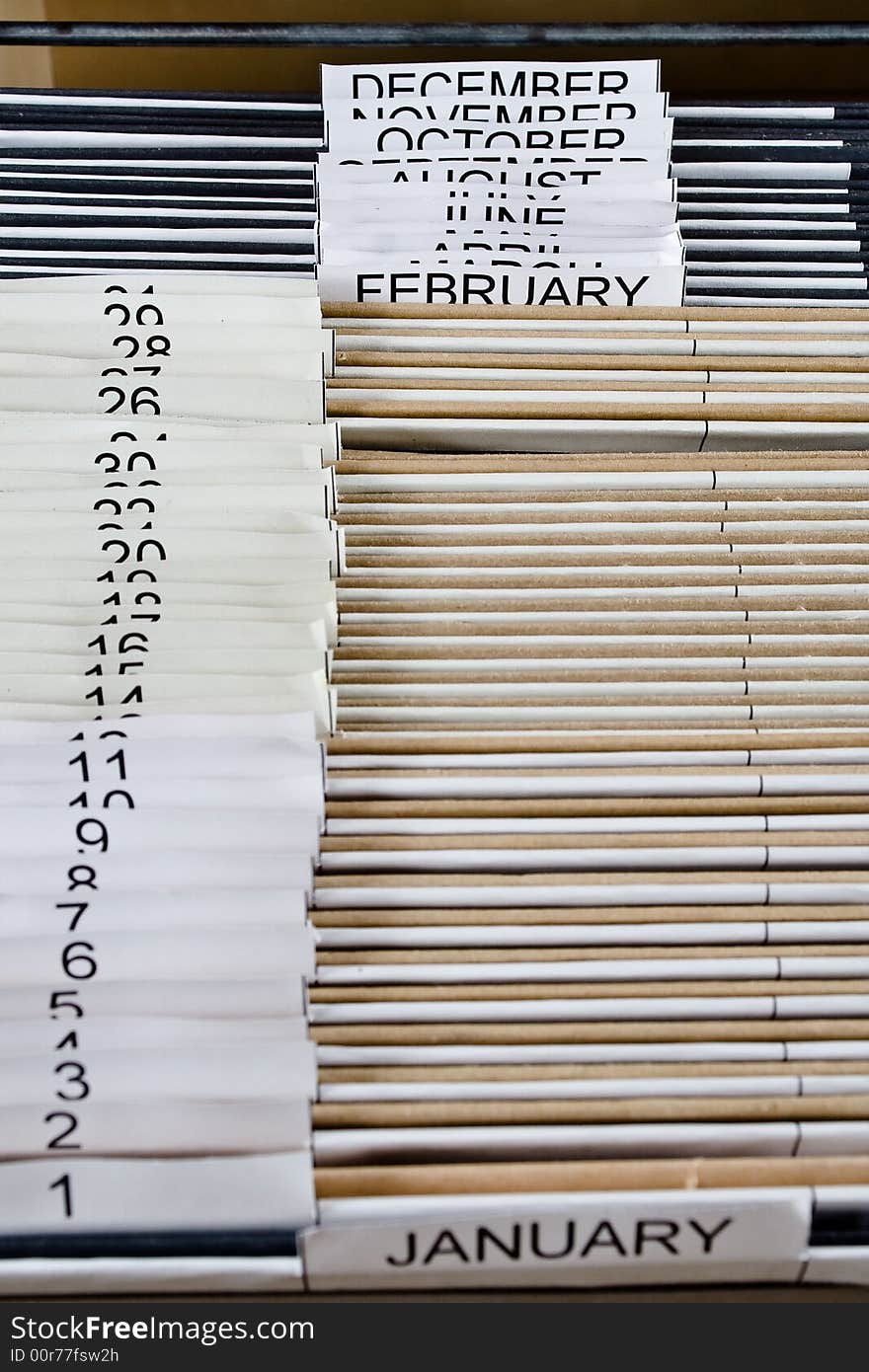 Wooden rolling file cabinet with a drawer opened, showing 43 hanging folders. Wooden rolling file cabinet with a drawer opened, showing 43 hanging folders.