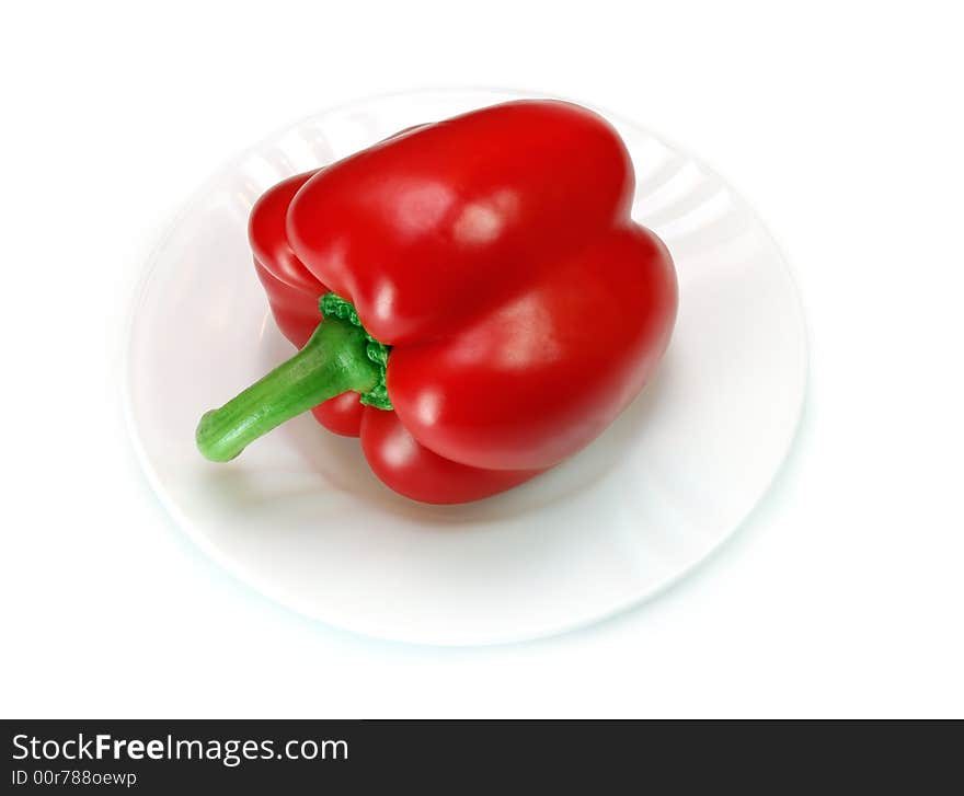 Red pepper on a plate isolated over a white background