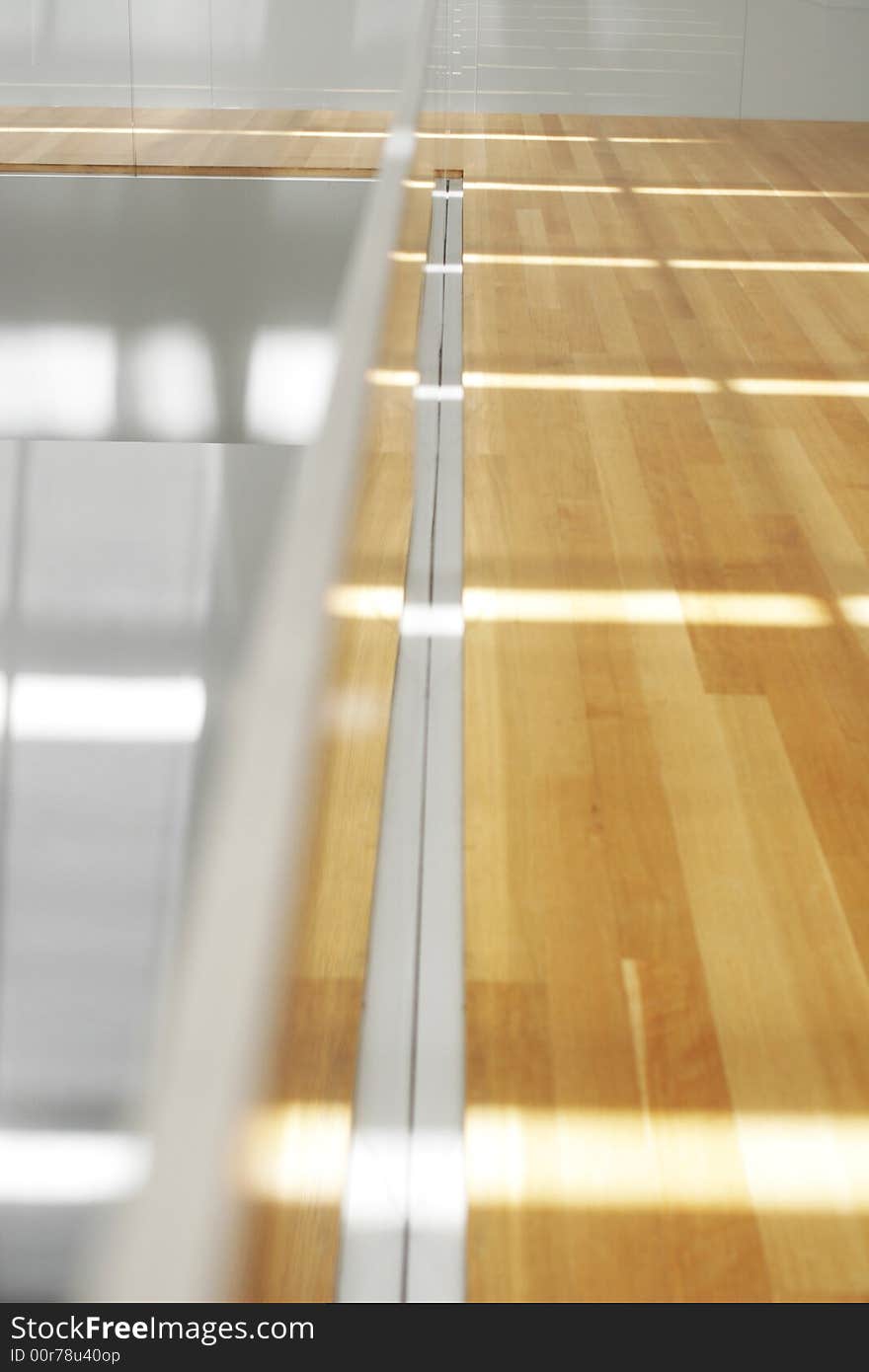 Clean sunlight filters onto blond wood floors. Clean sunlight filters onto blond wood floors