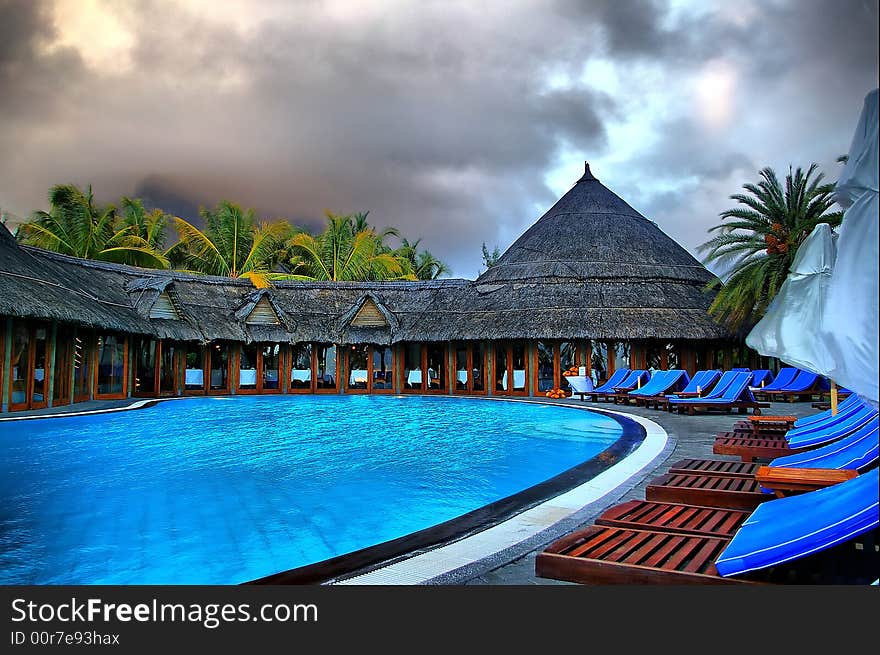 Large tropical outdoor swimming pool HDR image