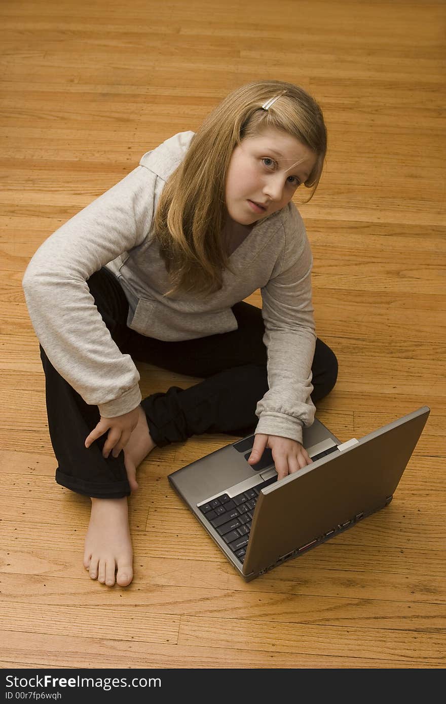 A young girl working on her laptop. A young girl working on her laptop