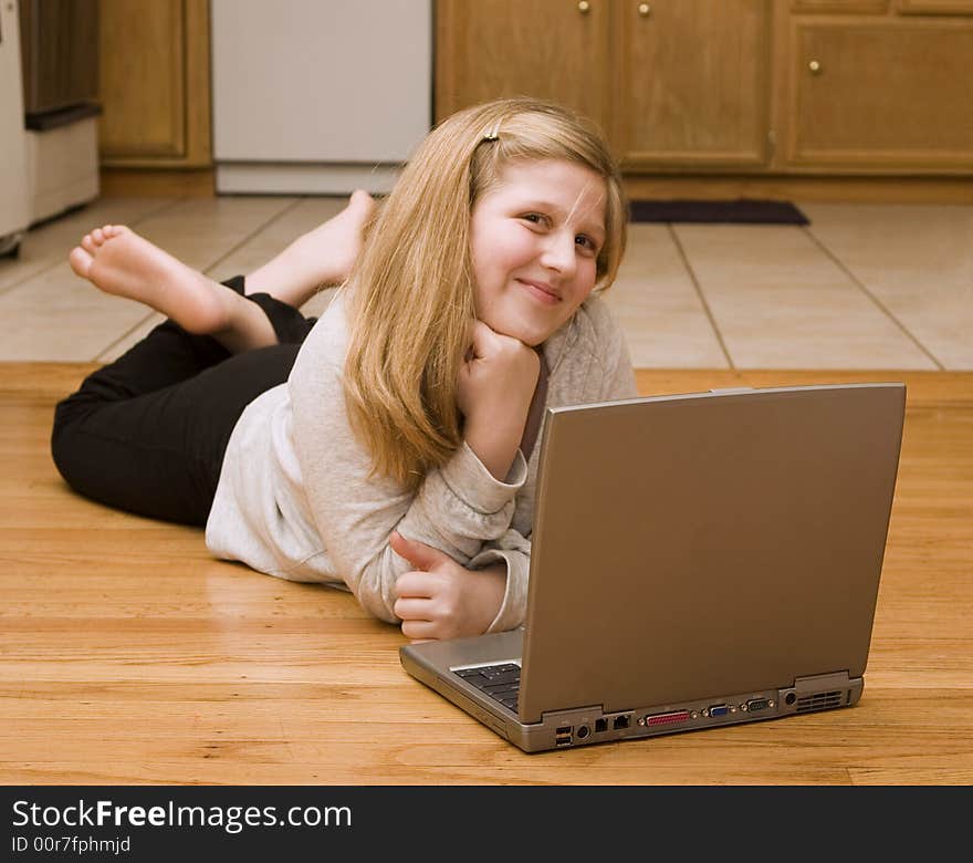 A young girl working on her laptop. A young girl working on her laptop