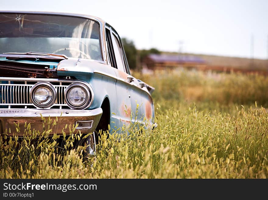 Abandoned car in field