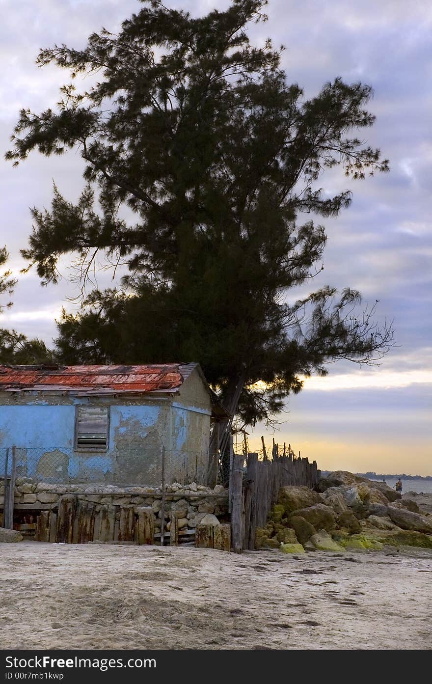 Beach scene with rustic cabin at sunset. Beach scene with rustic cabin at sunset