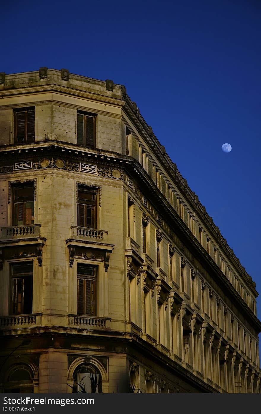 Old building facade in Havana - central park at dusk with early moon. Old building facade in Havana - central park at dusk with early moon