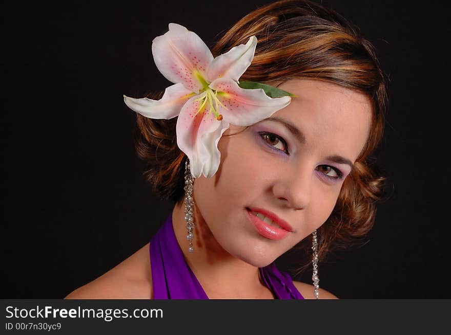 Portrait of beautiful female with lily flower on head. Portrait of beautiful female with lily flower on head