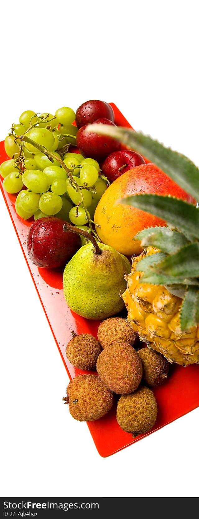 Assortment of fresh fruit arranged on a bright red serving dish. Assortment of fresh fruit arranged on a bright red serving dish.