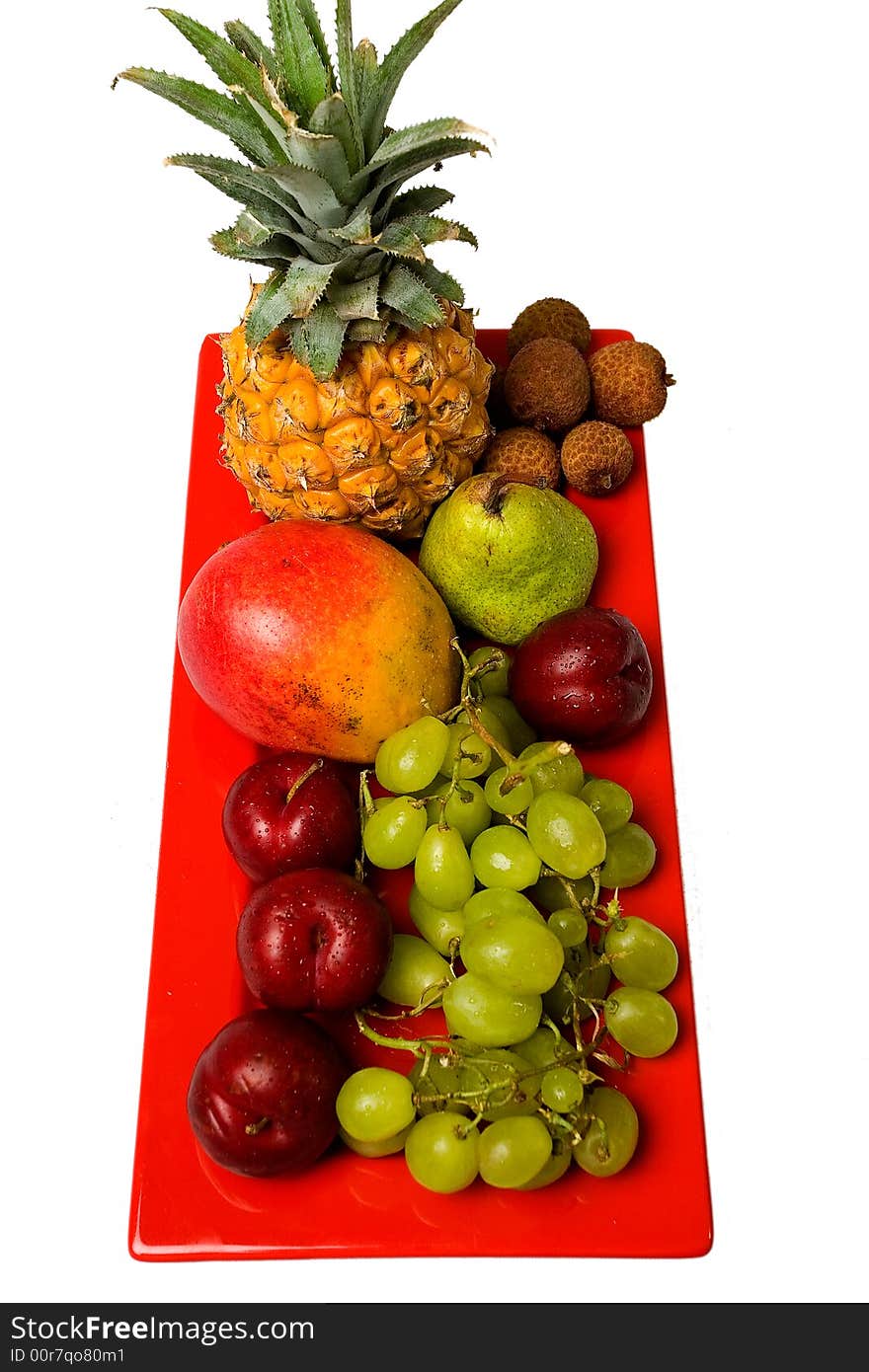 Assortment of fresh fruit arranged on a bright red serving dish. Assortment of fresh fruit arranged on a bright red serving dish.