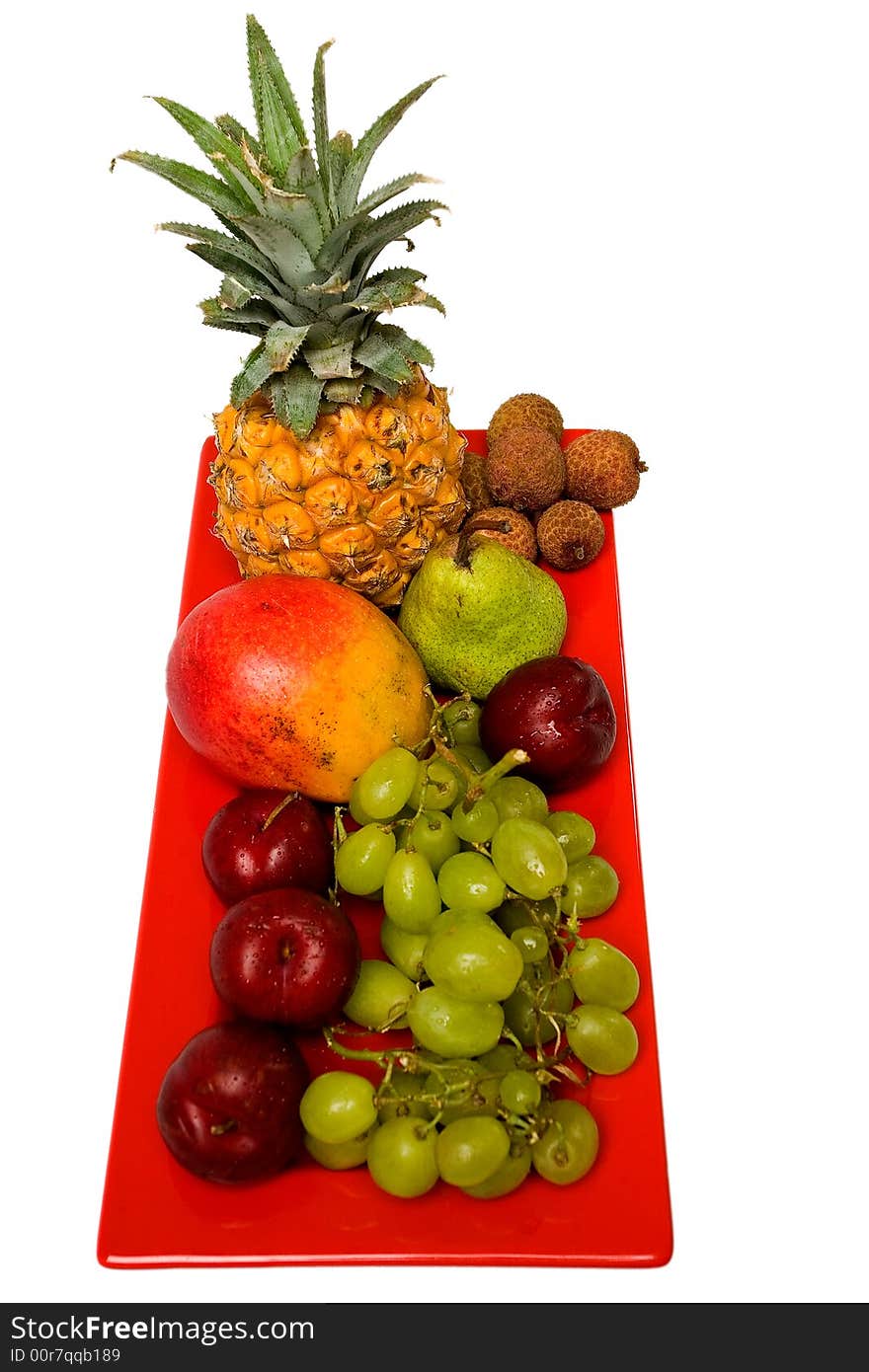 Assortment of fresh fruit arranged on a bright red serving dish. Assortment of fresh fruit arranged on a bright red serving dish.