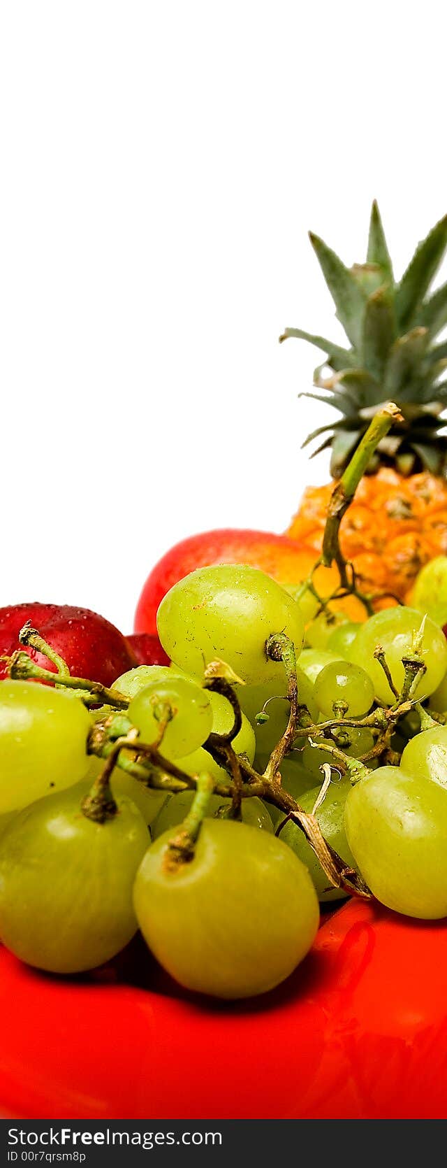 Assortment of fresh fruit arranged on a bright red serving dish. Assortment of fresh fruit arranged on a bright red serving dish.