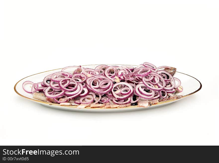 Herring with onion on the plate