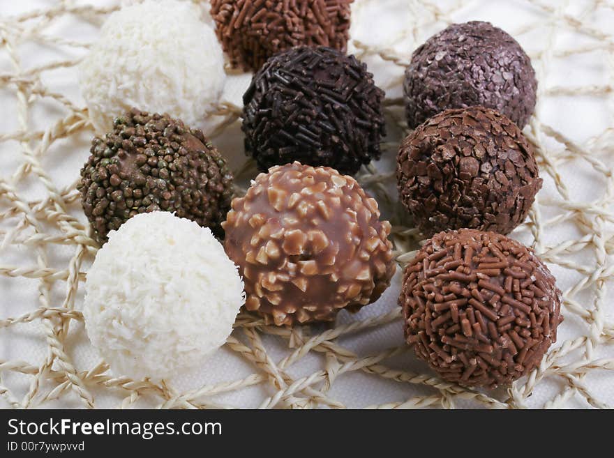 Various types of Chocolate truffles on handmade doily. Various types of Chocolate truffles on handmade doily