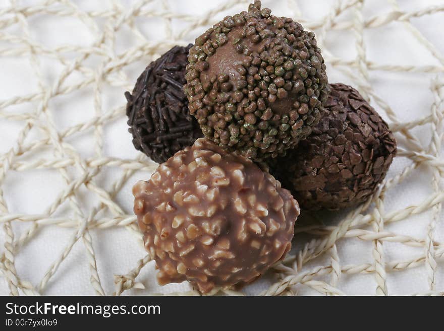 Various types of Chocolate truffles on handmade doily. Various types of Chocolate truffles on handmade doily