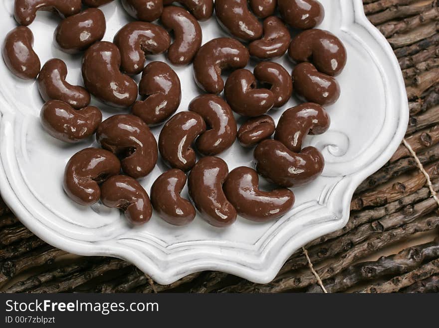 Yummy plate of chocolate covered cashew nuts for sharing or just one. Yummy plate of chocolate covered cashew nuts for sharing or just one.