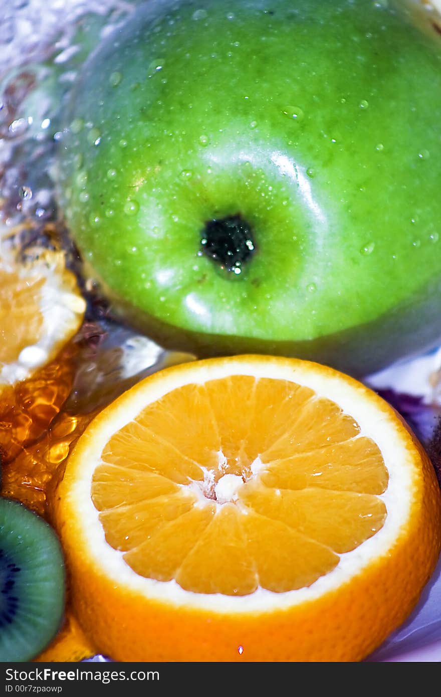 Green Apple And Orange Slice In Fresh Water