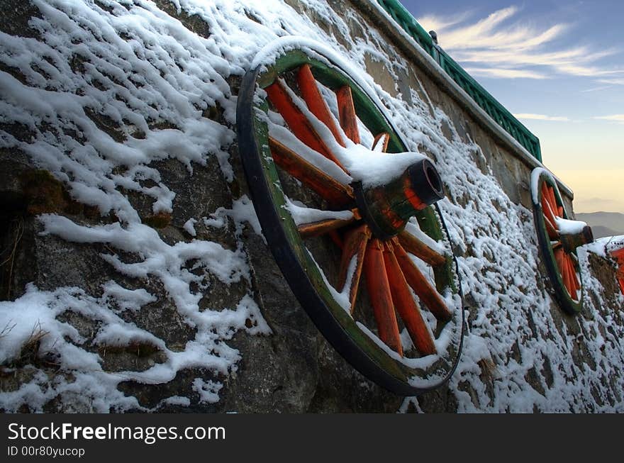 Two carriage wheels suspended on a wall