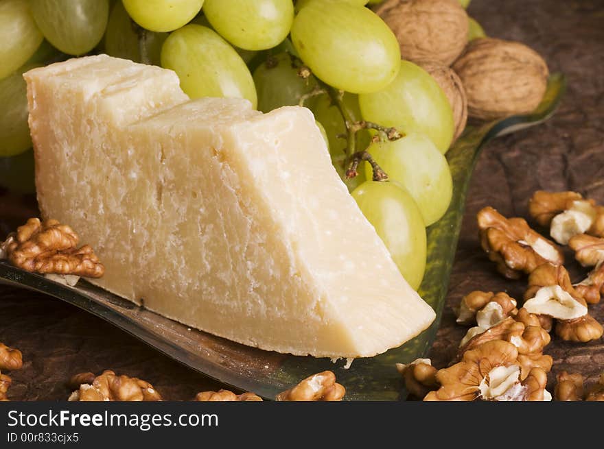 Close-up with cheese, grape, nuts  on a glass plate. Close-up with cheese, grape, nuts  on a glass plate.