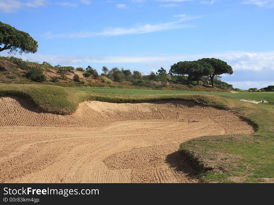 Detail of a sand bunker in a golf field (focus on the bunker)