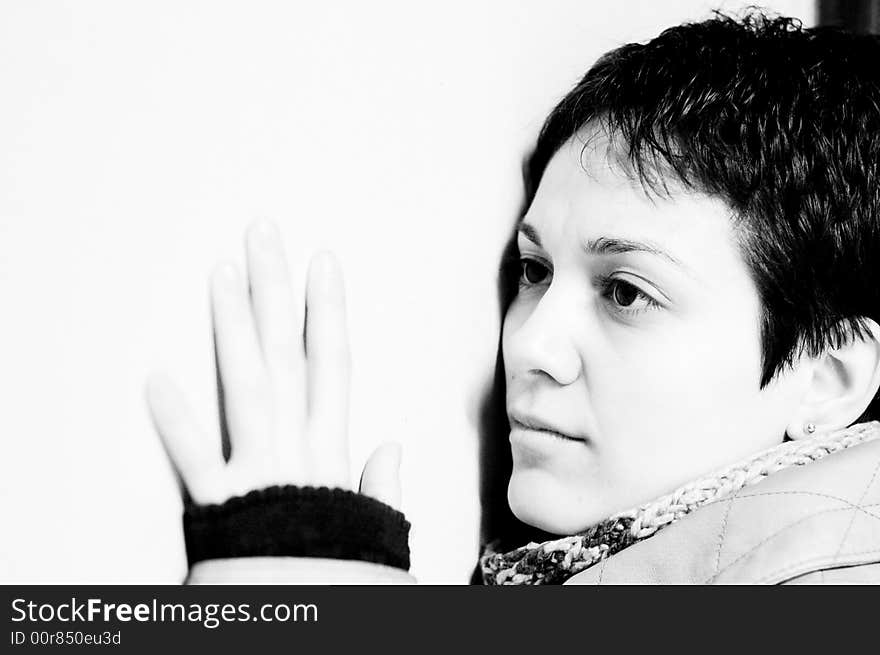 A view with a woman looking up thoughtful in black and white tones.