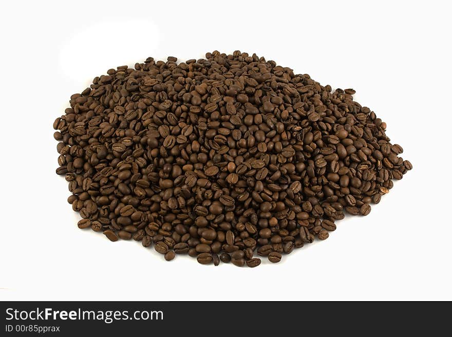 An isolated heap of coffee beans on white background. An isolated heap of coffee beans on white background