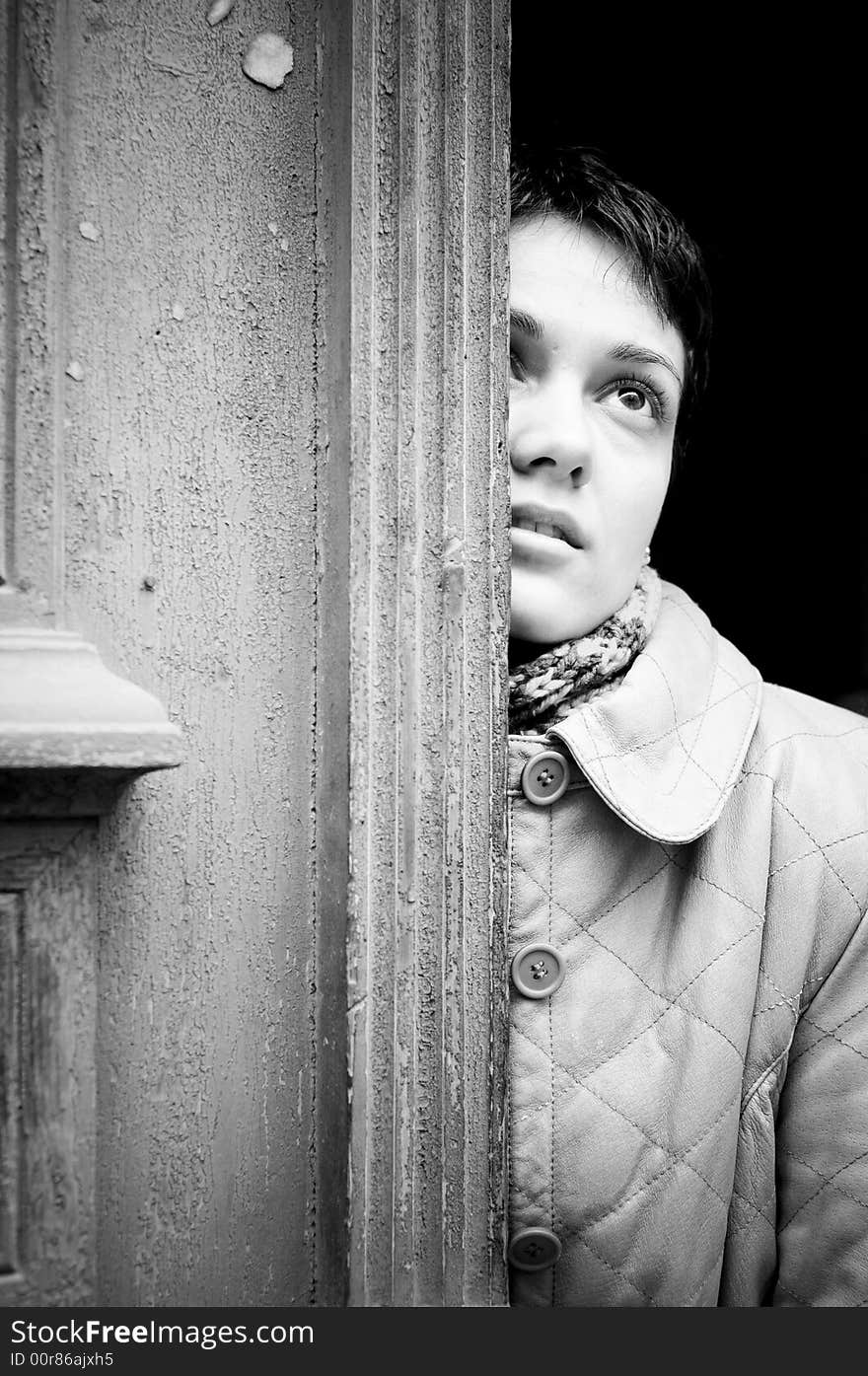 A view with a woman looking up thoughtful in black and white tones.