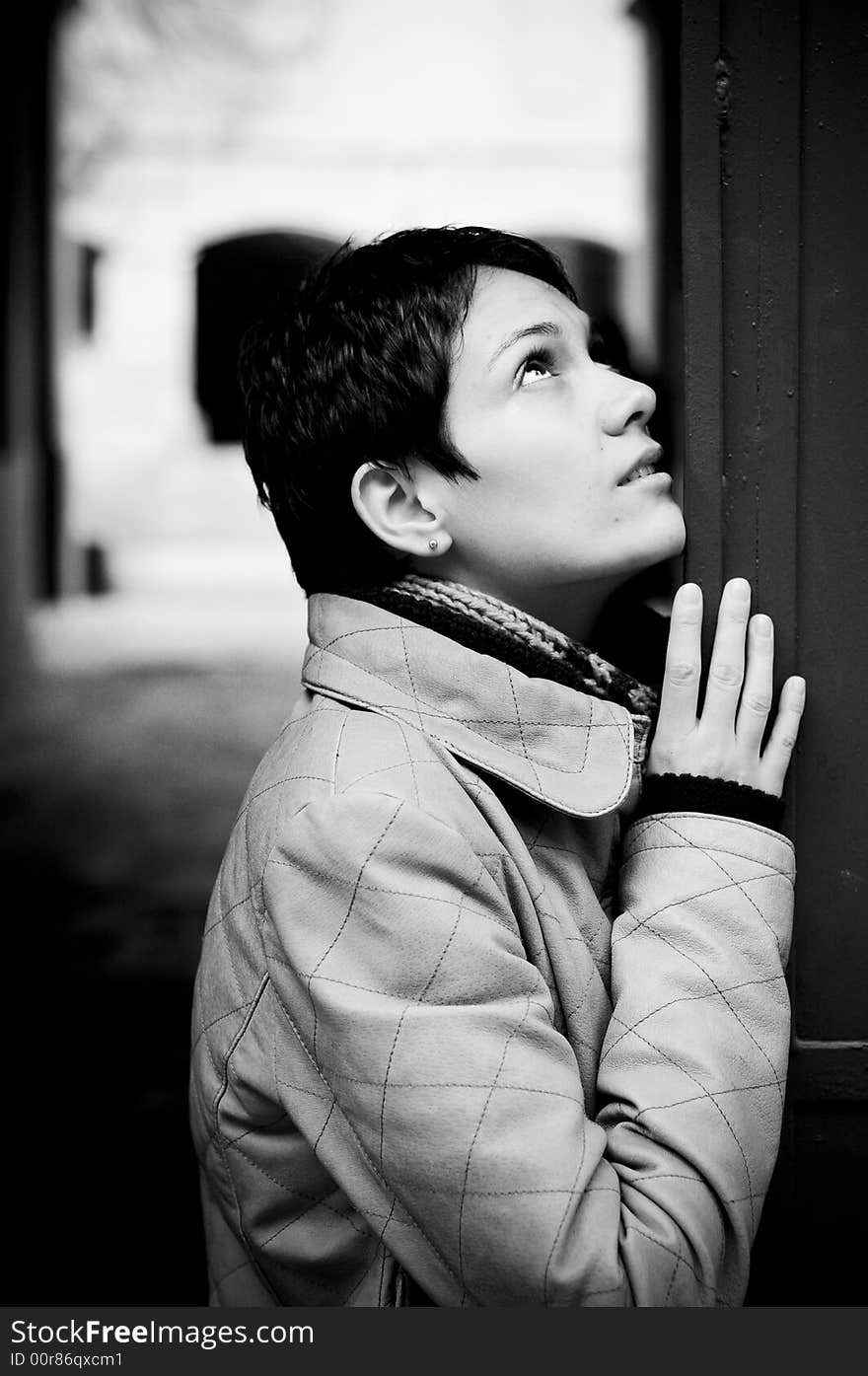 A view with a woman looking up thoughtful in black and white tones.