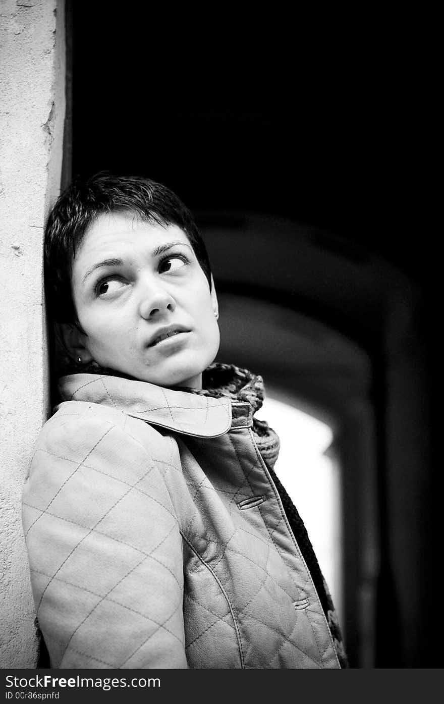 A view with a woman looking up thoughtful in black and white tones.