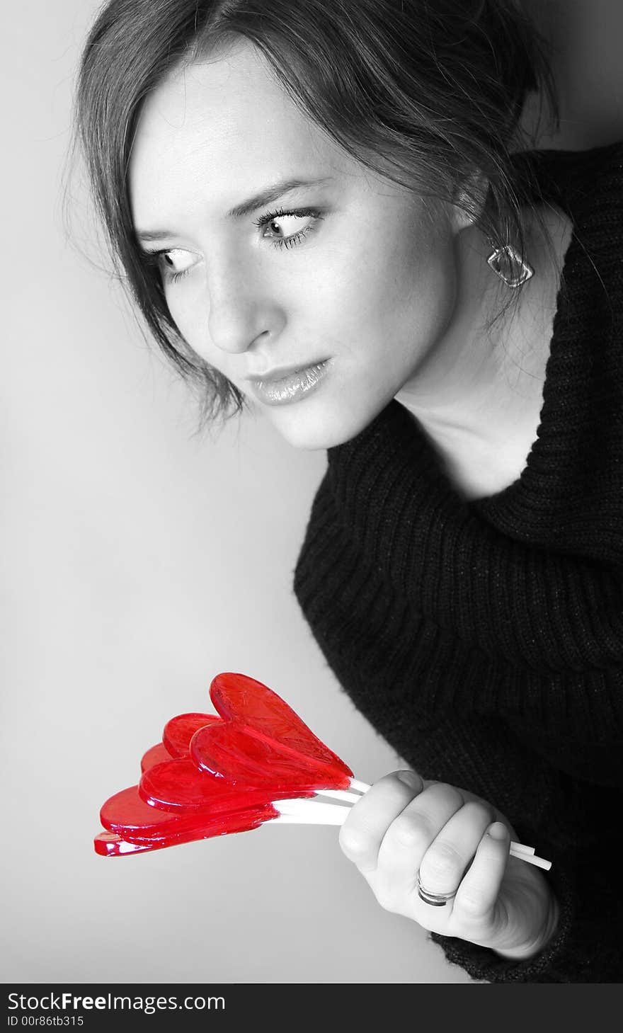 Valentine girl is holding lollipops in palm