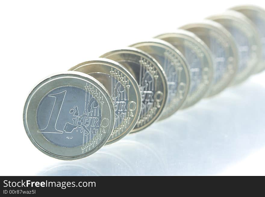 Euro coins line with reflection