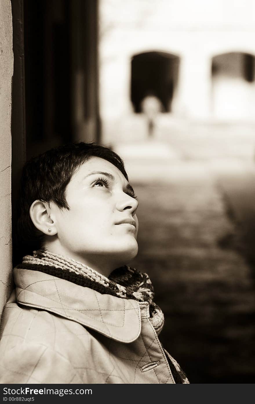 A view with a woman looking up thoughtful in sepia tones.