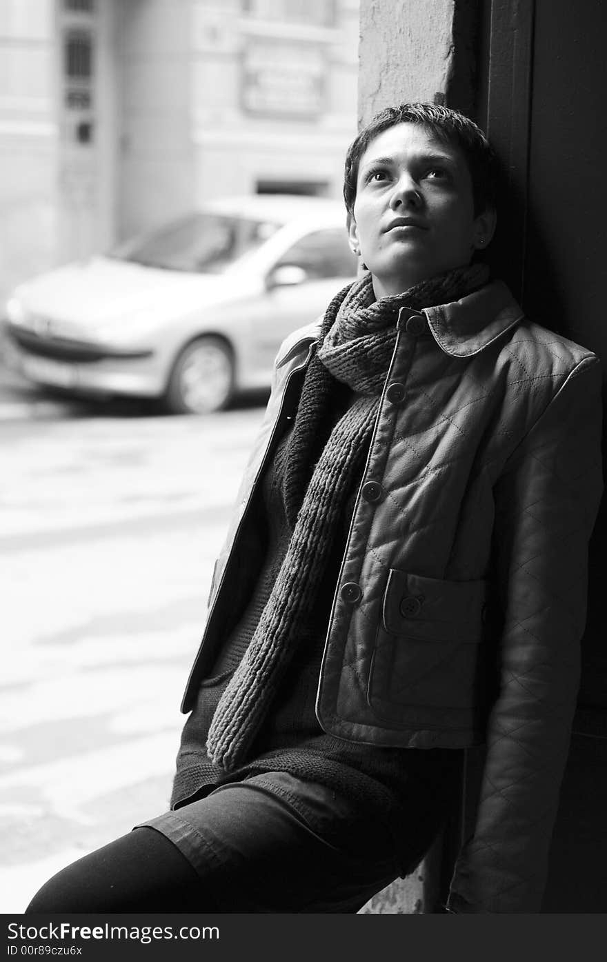 A view with a woman looking  thoughtful in black and white tones.