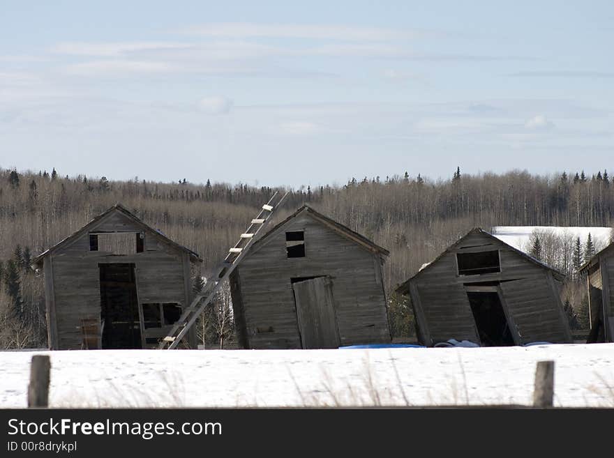 Three leaning outbuidings shoot in the winter. Three leaning outbuidings shoot in the winter.