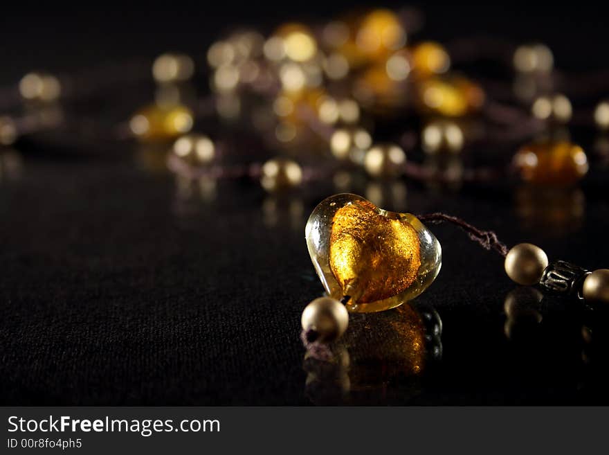 Amber heart on necklace with golden pearls