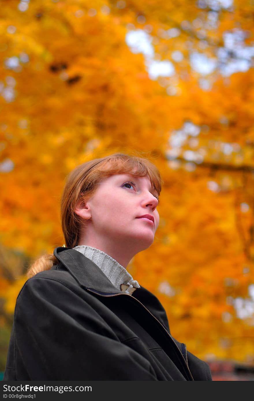 Woman look forward in autumn park