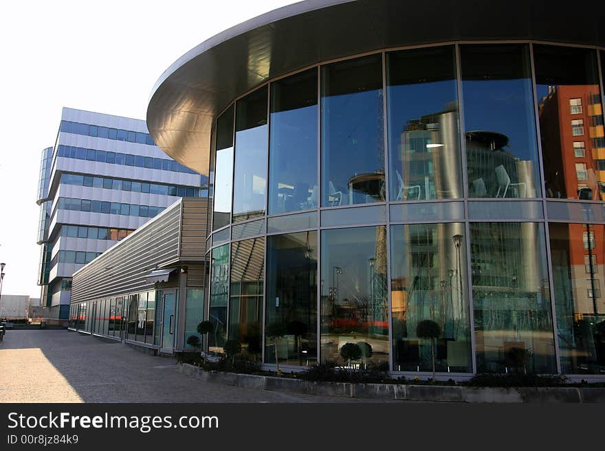 Modern work quarter - Blue buildings offices and round coffe bar structure. Italian architecture. Milan, Italy. Modern work quarter - Blue buildings offices and round coffe bar structure. Italian architecture. Milan, Italy