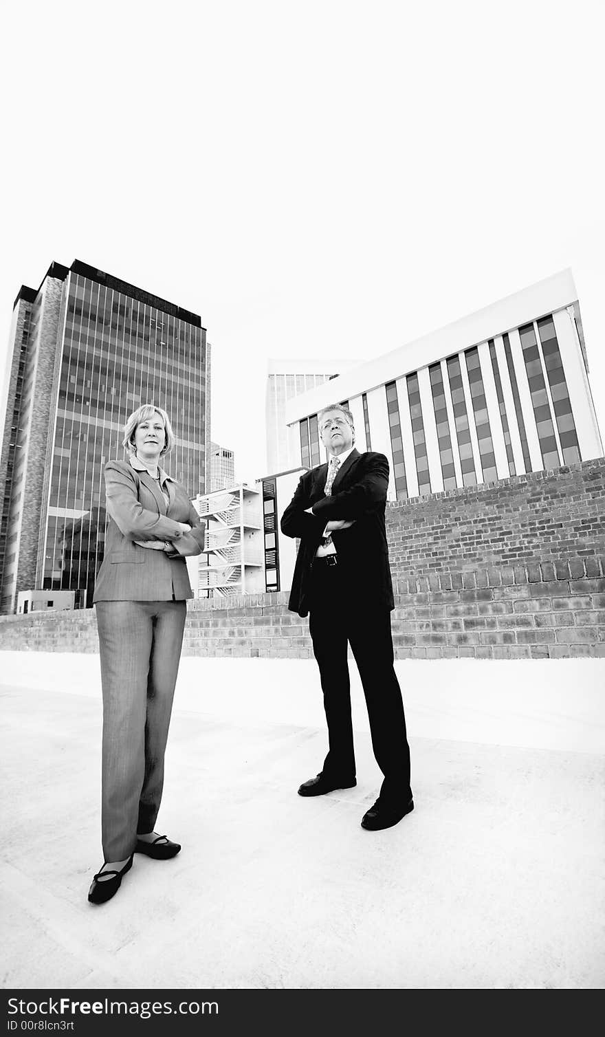 Executive man and woman on a downtown roof. Executive man and woman on a downtown roof