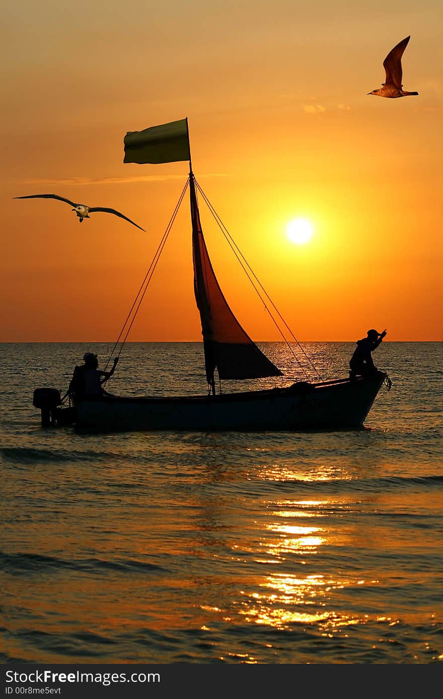 Silhouette three sailors in boat on background of the sundown. Silhouette three sailors in boat on background of the sundown