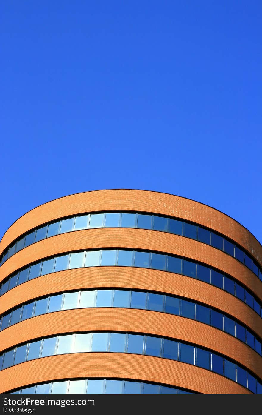 Modern tube-shaped building in Milan's work quarter. Top detail. Offices. Contemporary italian architecture Milan, Italy. Modern tube-shaped building in Milan's work quarter. Top detail. Offices. Contemporary italian architecture Milan, Italy