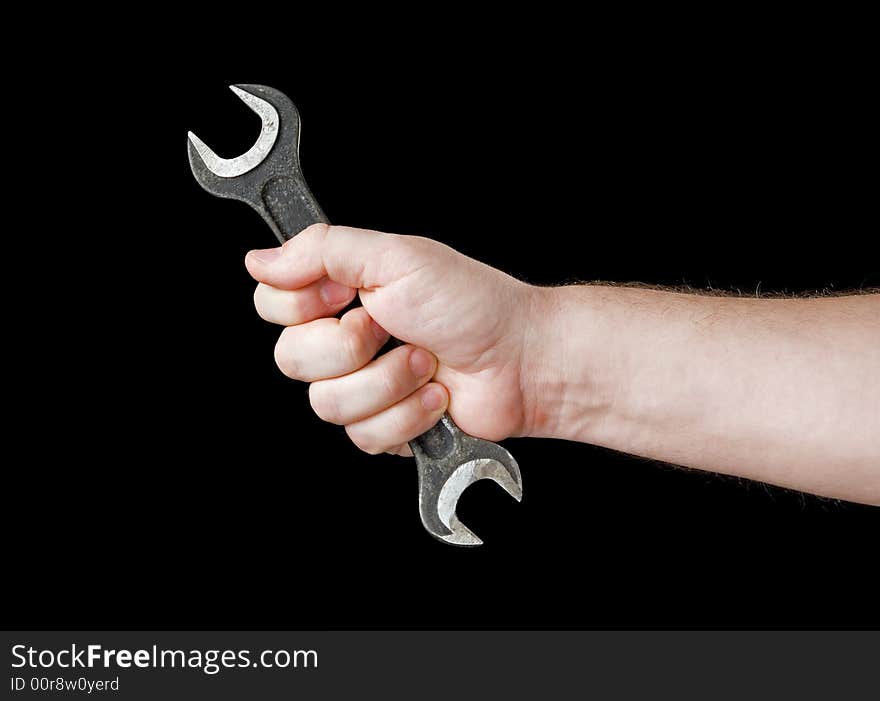 Wrench in hand. Isolated on a black background.