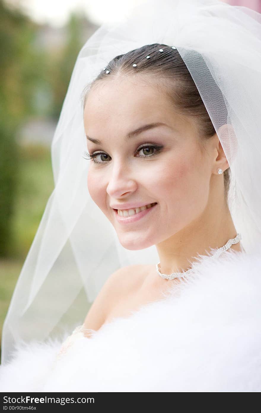 The beautiful bride in a fur cape