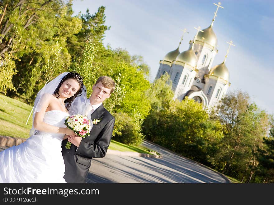 A bride and a groom near the church