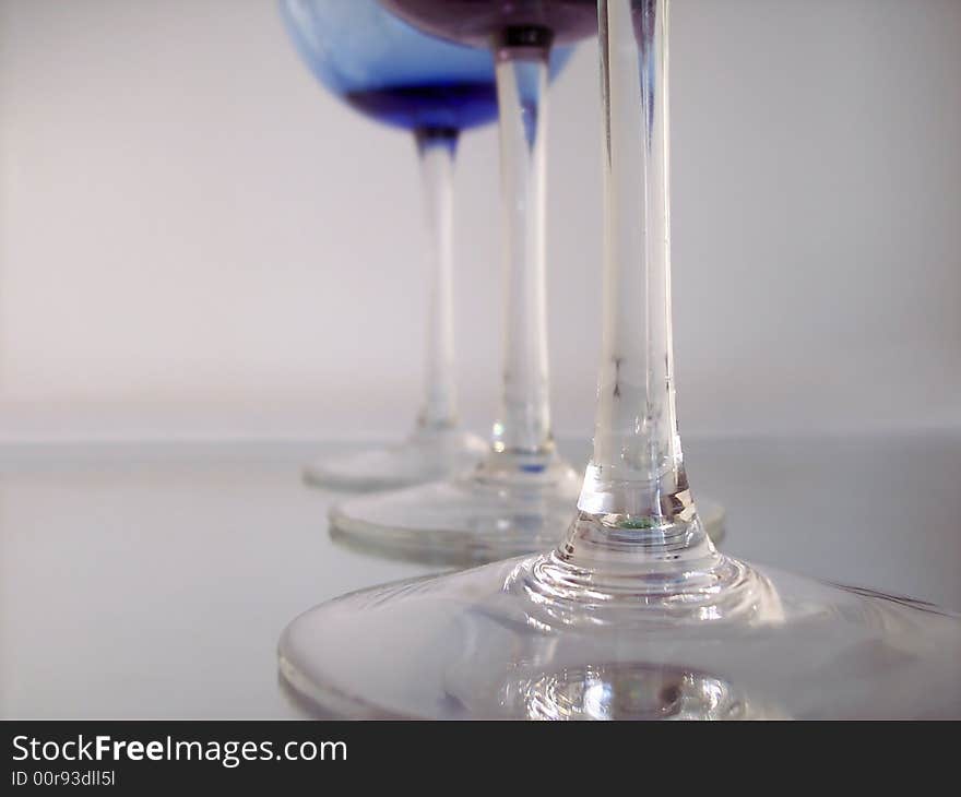 Different colored wine glasses arranged in different formations