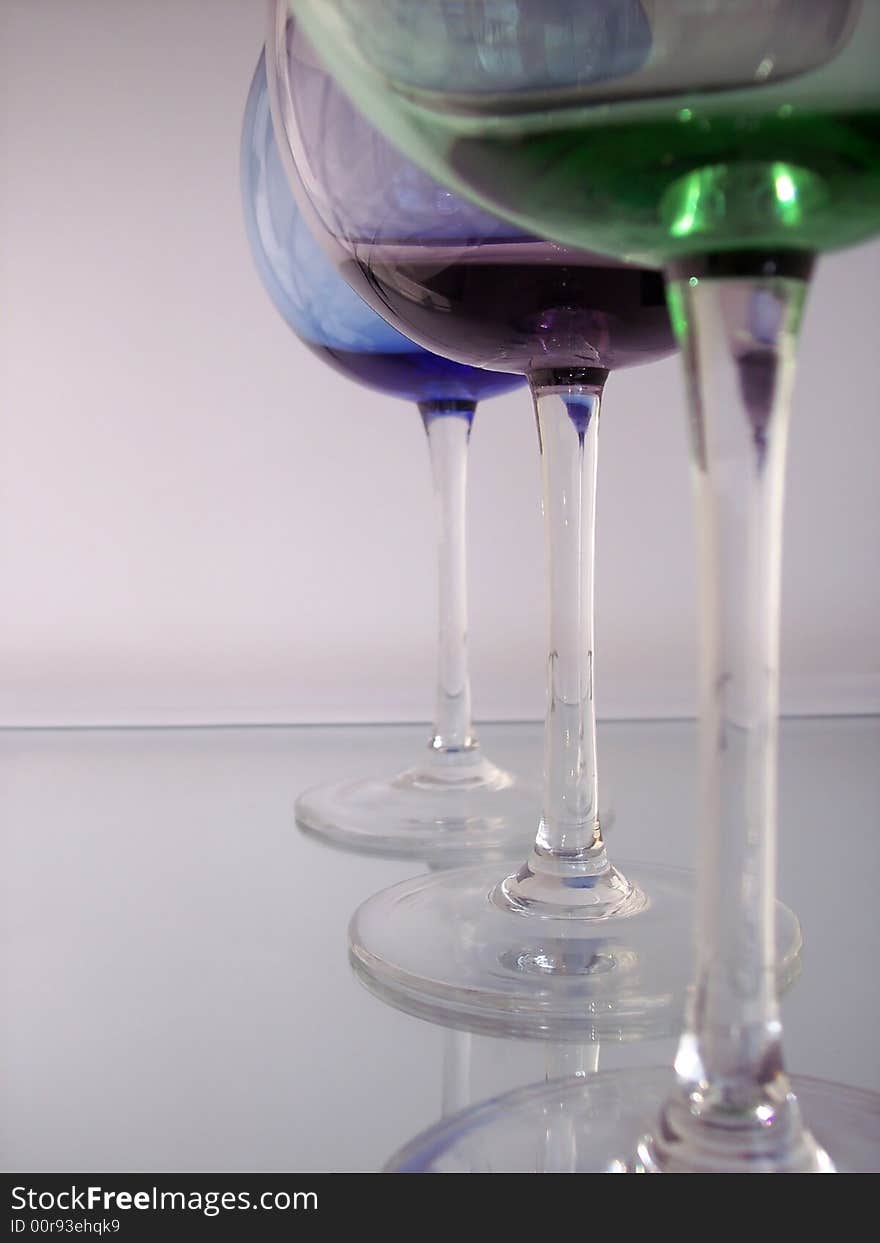 Different colored wine glasses arranged in different formations