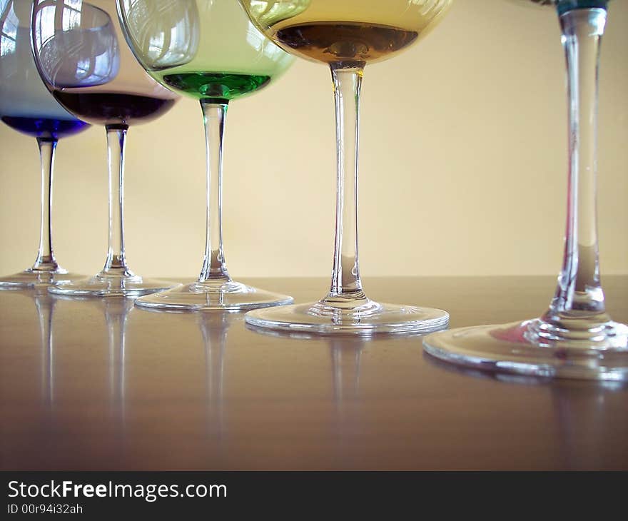 Different colored wine glasses arranged in different formations