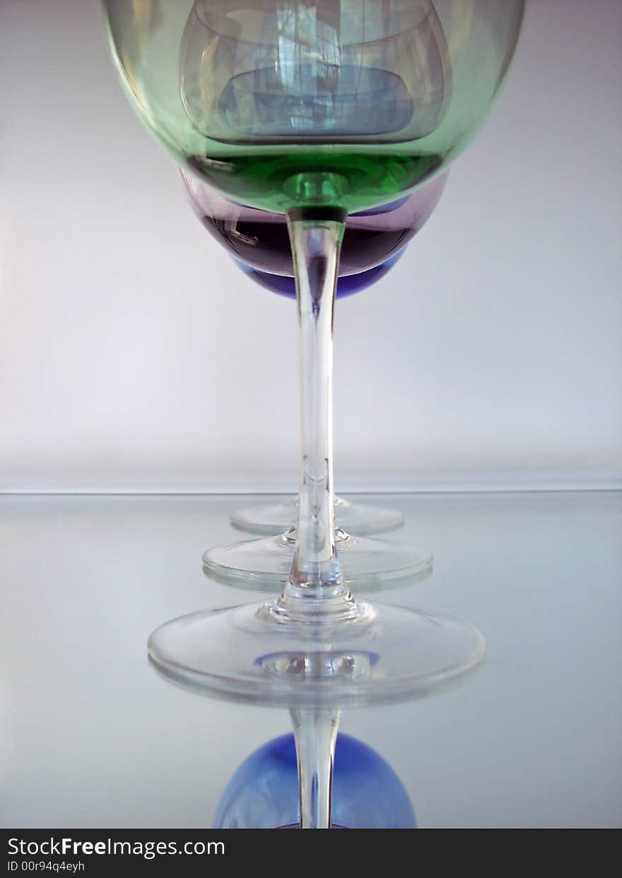 Different colored wine glasses arranged in different formations